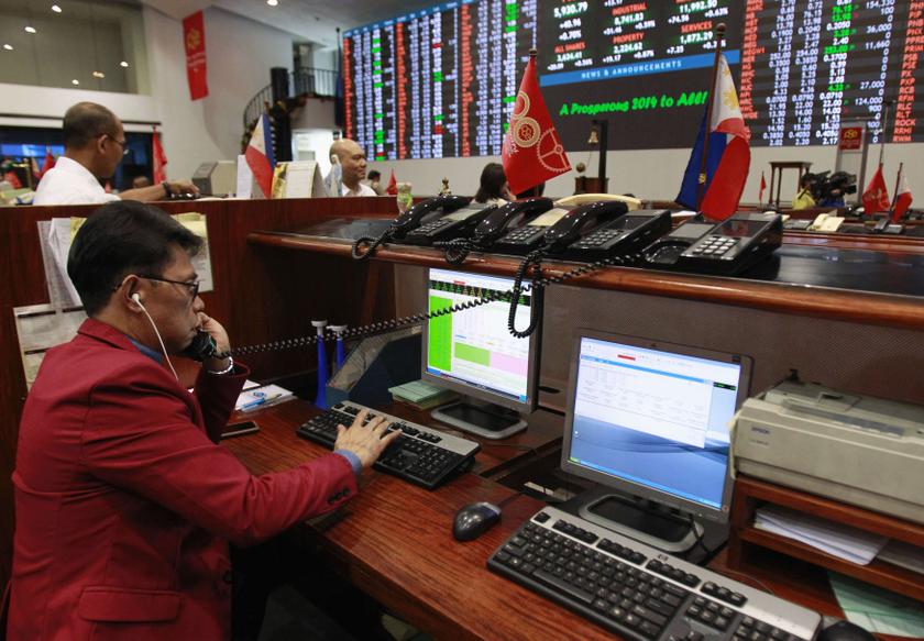 A trader works on a computer during the first day of trading for 2014, inside the Philippine Stock Exchange at the Makati financial district of Manila January 2, 2014. u00e2u20acu201d Reuters pic