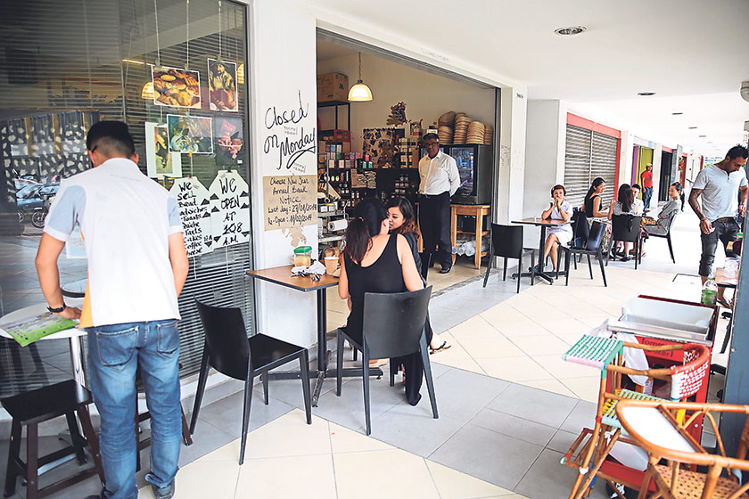 The cafe has a simple set-up with tables and chairs located on the footway