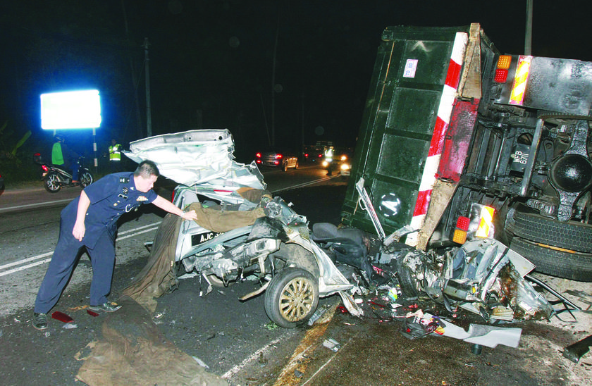 Total wreck: The car in which the four Utar students were travelling in is smashed to bits after colliding with a lorry. u00e2u20acu201d Picture by The Malay Mail