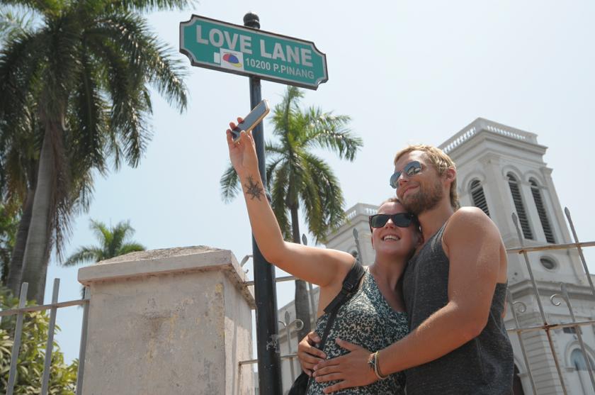 Tom and Kate taking their portrait at Love Lane, Penang for their valentine memory during their visit to Kuala Lumpur, February 14, 2014. u00e2u20acu201d Picture by K.E. Ooi