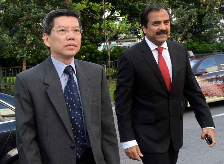 Former top civil servant Peter Lim (left) arrives with his lawyer at the Subordinate courts in Singapore on June 13, 2013. A Singapore court today jailed a top diplomat for 15 months for making false claims. u00e2u20acu201d AFP pic