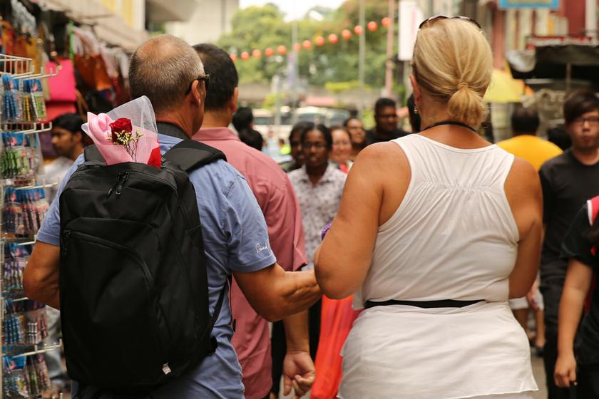 Tourists and locals walking down Petaling Street looking at Valentine's Day bouquets and flowers on February 14, 2014. u00e2u20acu201d Picture by Saw Siow Feng