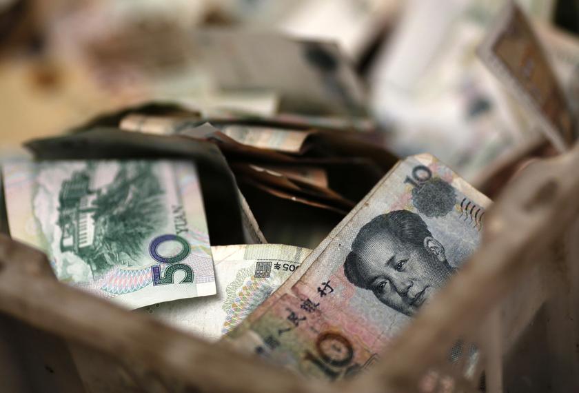 Chinese banknotes are seen at a vendor's cash box at a market in Beijing February 14, 2014. u00e2u20acu201d Reuters pic
