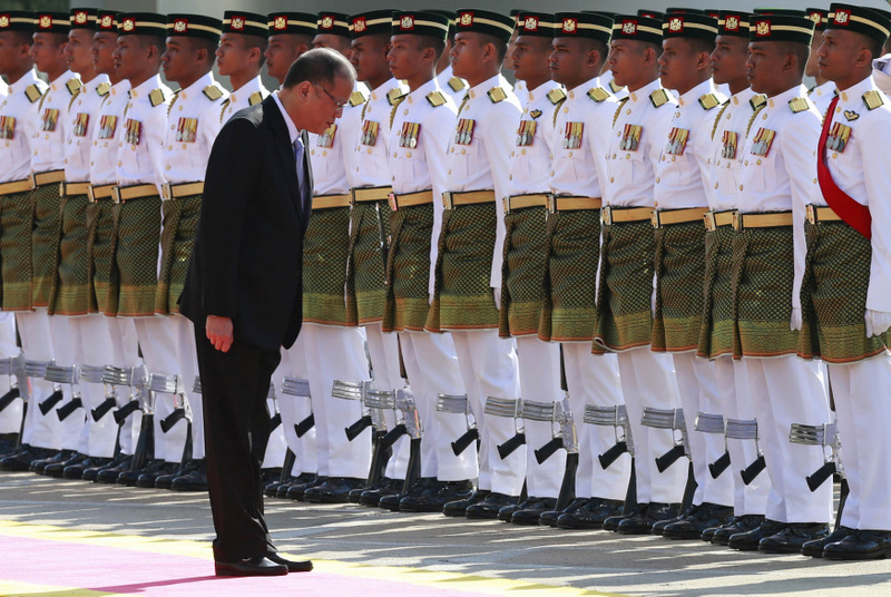 Philippines President Benigno Aquino takes a bow as he inspects an honour guard during a state welcoming ceremony outside the Parliament house in Kuala Lumpur February 28, 2014. u00e2u20acu201d Reuters pic