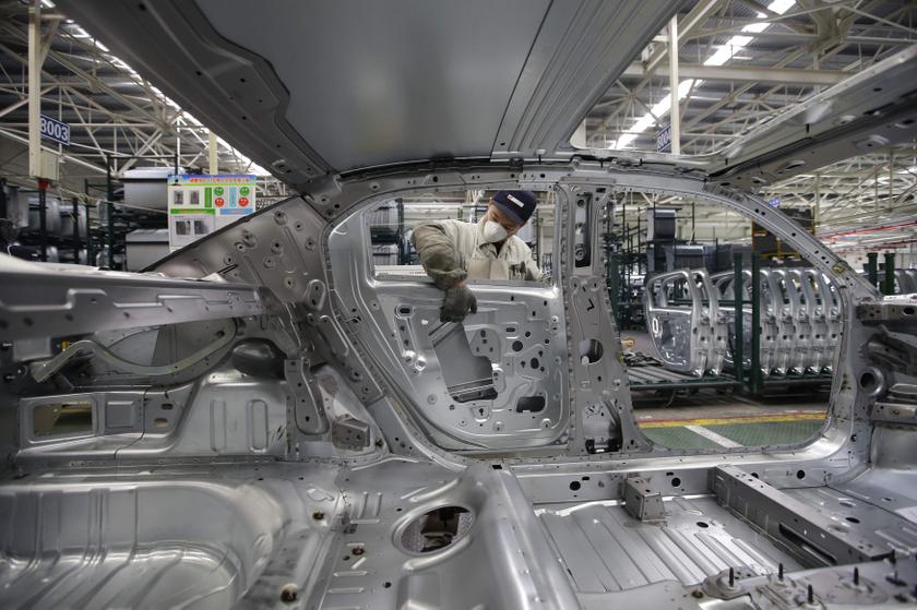 An employee installs car doors at a production line of Dongfeng Peugeot Citroen Automobile factory in Wuhan, Hubei province, February 18, 2014. u00e2u20acu201d Reuters pic