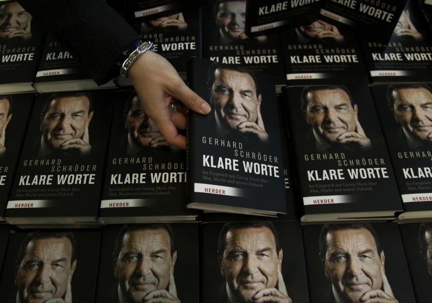 An employee aligns books before the news conference of former German Chancellor Gerhard Schroeder to promote his latest book u00e2u20acu02dcKlare Worteu00e2u20acu2122 (Clear Words) in Berlin February in this file photo. u00e2u20acu201d Reuters pic