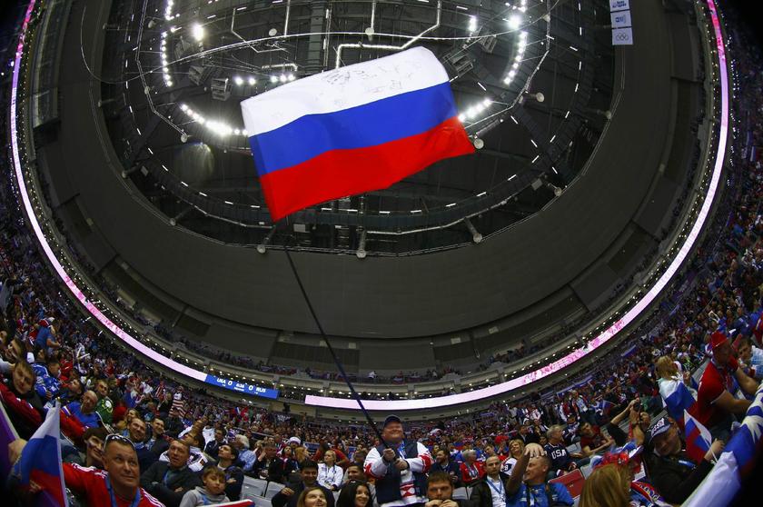 A fan waves a Russian flag before the men's preliminary round hockey game between Russia and USA at the Sochi 2014 Winter Olympics February 15, 2014. Picture taken with a fisheye lens Reuters