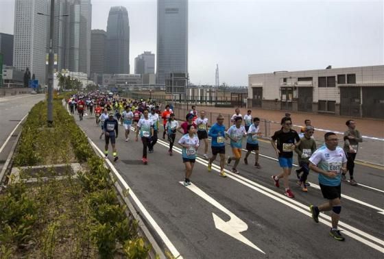 Participants run past Two International Finance Centre (IFC), as they compete in the Hong Kong marathon February 16, 2014 Reuters