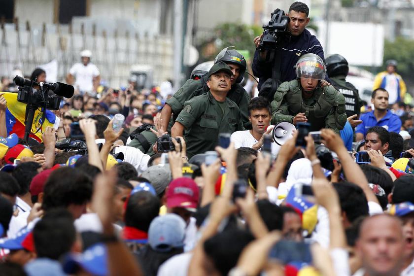 Venezuela opposition leader Leopoldo Lopez (C) speaks to supporters blocking a street after he handed himself over in Caracas February 18, 2014 Reuters