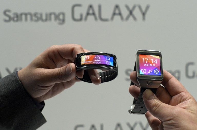 The Samsung Galaxy Gear Fit (left) and Samsung Galaxy Gear 2 presented at the 2014 Mobile World Congress. — AFP pic