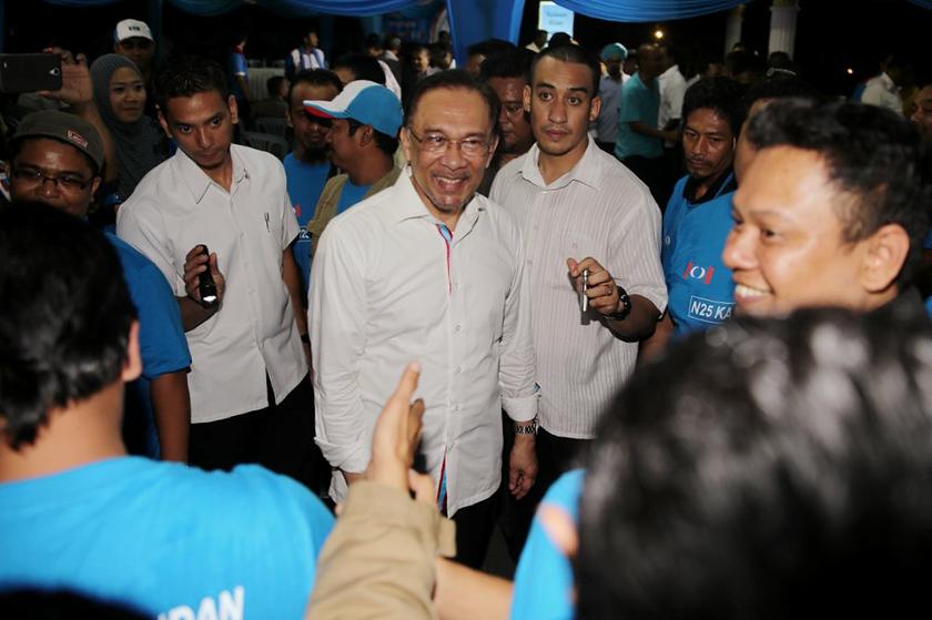 Anwar shakes hands with PKR members that will be helping out during the Kajang by-election. u00e2u20acu201d Picture by Choo Choy May