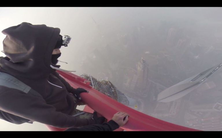 A screencap of the video where daredevils scaled the world's second tallest building in China.