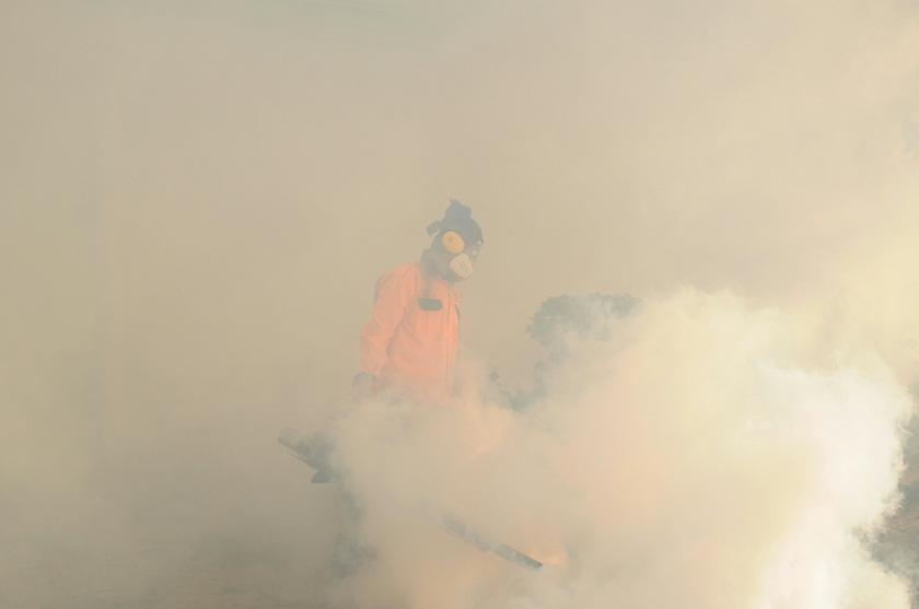 A health department personnel seen mosquito-fogging a residential area. on February 24, 2014. There has been more dengue cases reported this year compared to the same time last year. u00e2u20acu201d Picture by K.E. Ooin
