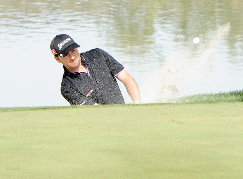 Graeme McDowell plays from the greenside bunker during the third round of the World Golf Championships-Accenture Match Play Championship at The Golf Club at Dove Mountain, February 21, 2014. u00e2u20acu201d Casey Sapio-USA TODAY/Reuters pic