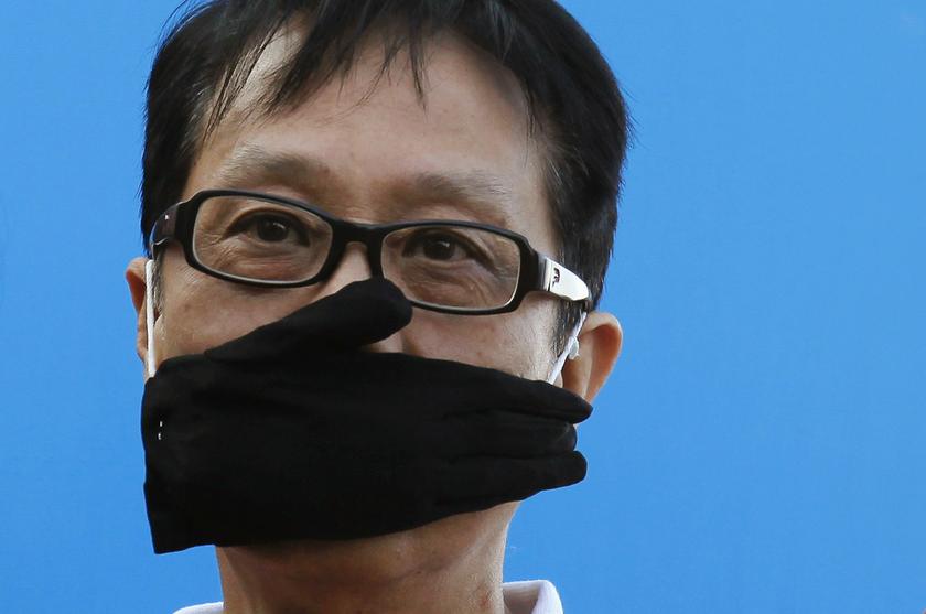 A protester covers his mouth with a glove during a demonstration demanding freedom of speech and press freedom in Hong Kong February 23, 2014. u00e2u20acu201d Reuters pic