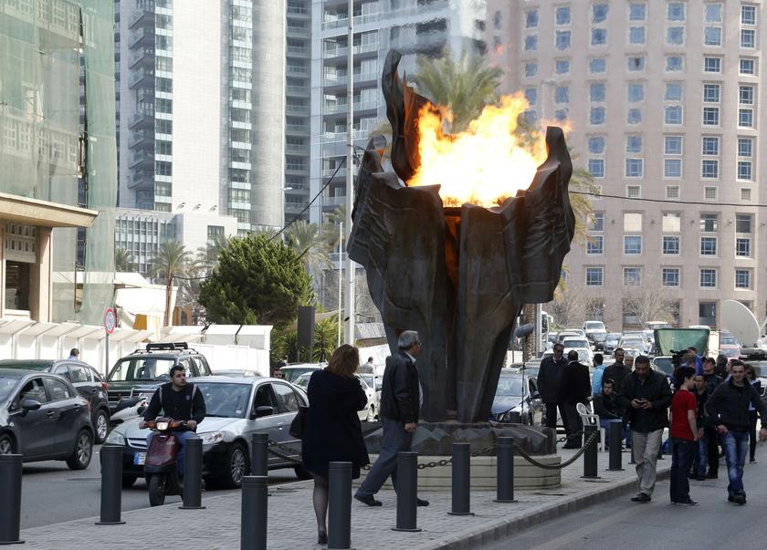 Supporters of the Future Movement bloc light a torch at the site of the suicide truck bombing that killed Lebanon's assassinated former prime minister Rafik al-Hariri in 2005, in Beirut February 14, 2014. u00e2u20acu201d Reuters pic