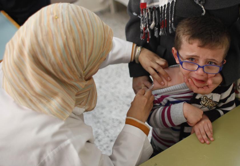 A Palestinian boy receives polio vaccine at a hospital in Khan Younis in the southern of Gaza Strip February 23, 2014. u00e2u20acu201d Reuters pic