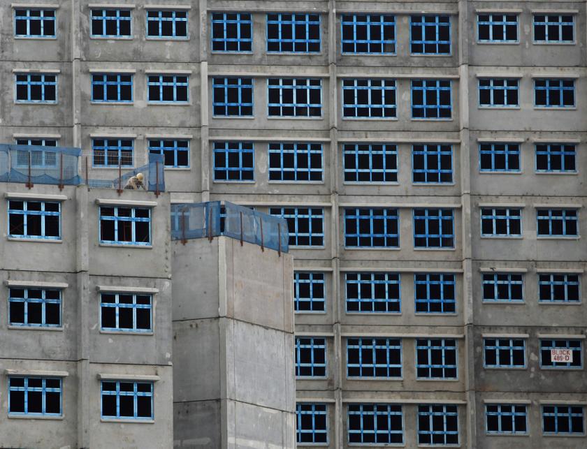 A construction labourer works at a public housing construction site in Singapore January 23, 2014. u00e2u20acu201d Reuters pic