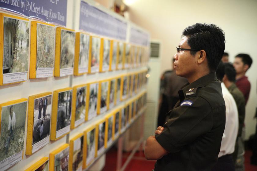 An immigration officer looks at a display presented by authorities that investigated an alleged massacre of Rohingya Muslims in Myanmar's Rakhine state in the Foreign Affairs Minister office in Yangon January 28, 2013. u00e2u20acu201d Reuters pic