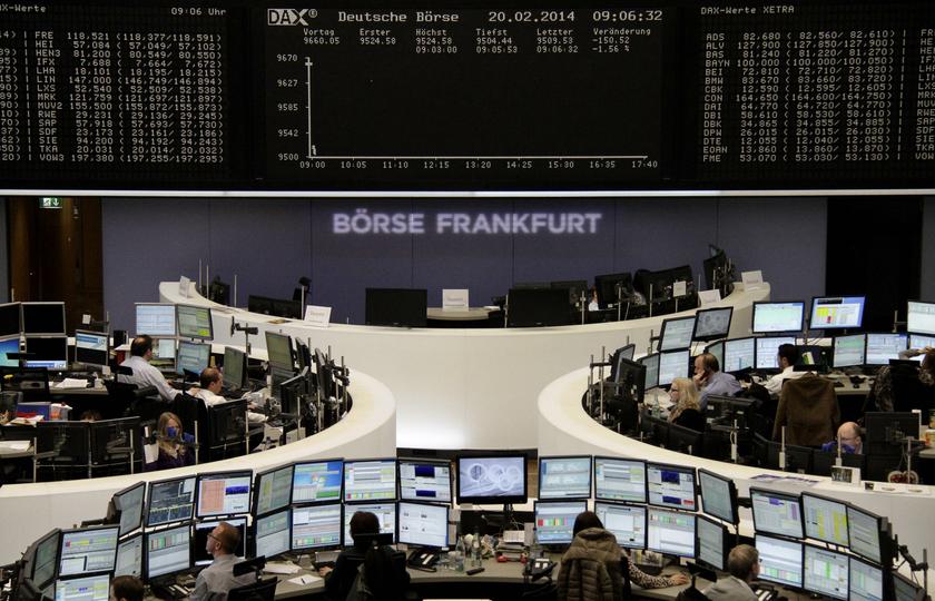 Traders are pictured at their desks in front of the DAX board at the Frankfurt stock exchange February 20, 2014. u00e2u20acu201d Reuters pic