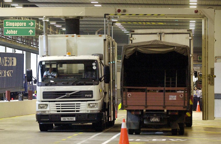 A mobile x-ray machine (vehicle-L) scans through a Malaysian lorry at the Woodlands immigration checkpoint leading to Johor Baru from Singapore, 16 April 2002. u00e2u20acu201d AFP pic
