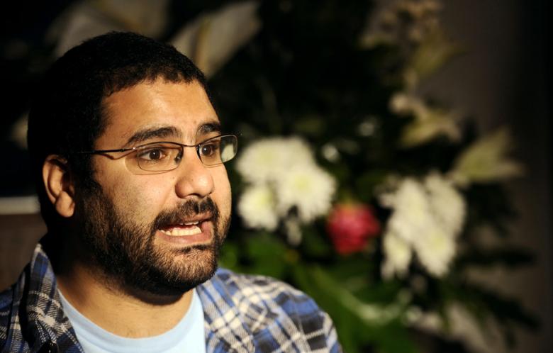 Egyptian blogger and activist Alaa Abdel Fattah speaks during a TV interview at his house in Cairo on December 26, 2011, a day after his release.  u00e2u20acu201d AFP pic