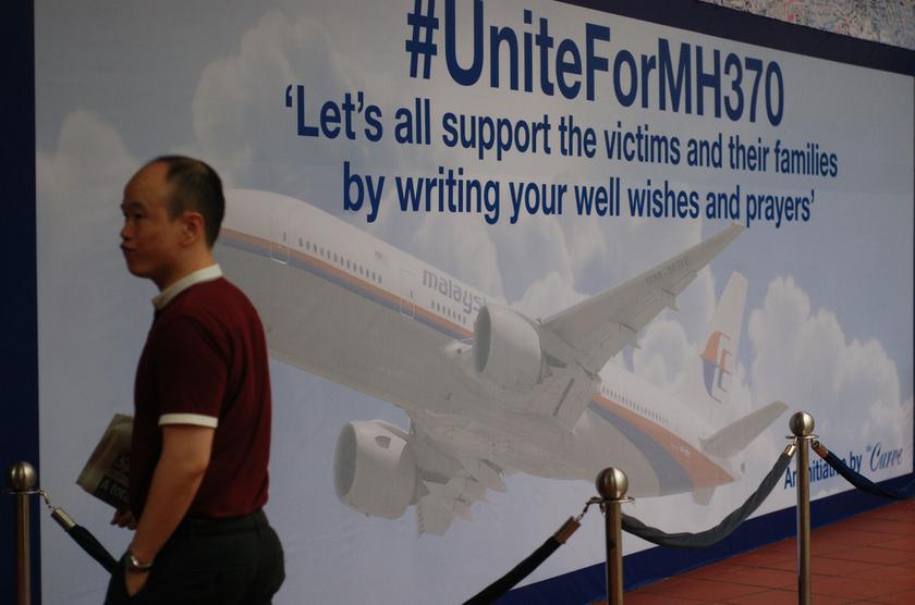 A man walks by a large signboard with a messages of support left for family members and passengers onboard the missing Malaysia Airlines Flight MH370 at The Curve, Petaling Jaya March 18, 2014. u00e2u20acu201d Picture by Yusof Mat Isa