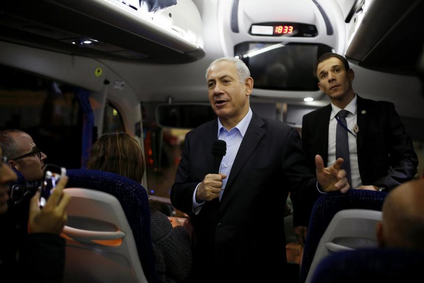 Israel's Prime Minister Benjamin Netanyahu (centre) speaks to members of the media aboard a bus in the Red Sea resort city of Eilat March 10, 2014. u00e2u20acu201d Reuters pic