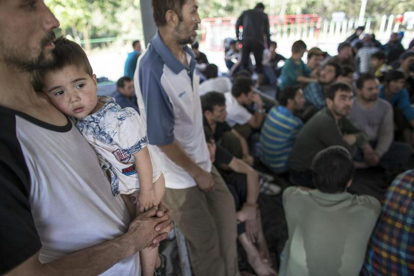A suspected Uighur from China's troubled far-western region of Xinjiang, holds his son at a temporally shelter after they were detained at the immigration regional headquarters near the Thailand-Malaysia border in Hat Yai, Songkla March 14, 2014. u00e2u20acu201d Reut
