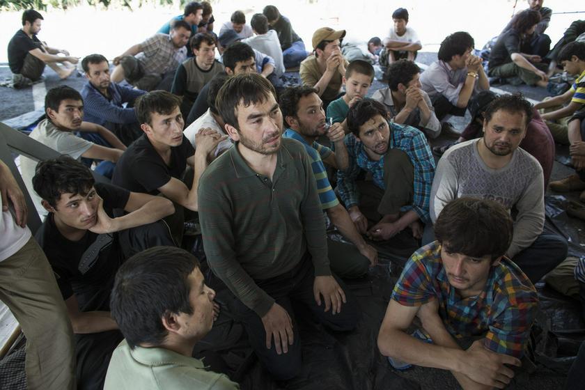 Suspected Uighurs from China's troubled far-western region of Xinjiang, sit inside a temporary shelter after they were detained at the immigration regional headquarters near the Thailand-Malaysia border in Hat Yai, Songkla March 14, 2014. u00e2u20acu201d Reuters pic