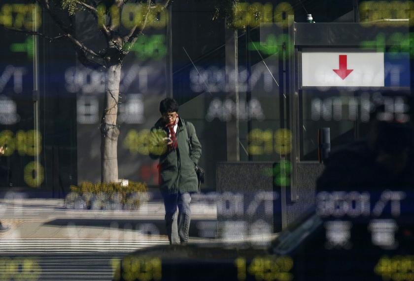 A man is reflected in a stock quotation board outside a brokerage in Tokyo January 28, 2014. u00e2u20acu201d Reuters pic