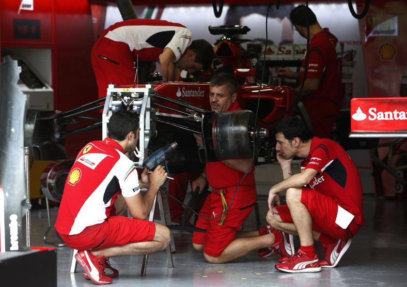 Mechanics work on the car of Ferrari Formula One driver Fernando Alonso of Spain ahead of the Malaysian F1 Grand Prix at Sepang International Circuit outside Kuala Lumpur, March 27, 2014. u00e2u20acu201d Reuters pic