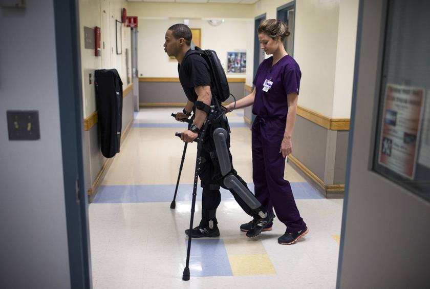 Errol Samuels from Queens, New York, walks with a ReWalk electric powered exoskeletal suit during a therapy session with Alexandra Voigt, a clinical research coordinator and therapist, at the Mount Sinai Medical Center in New York City, March 30, 2014. u00e2u20ac