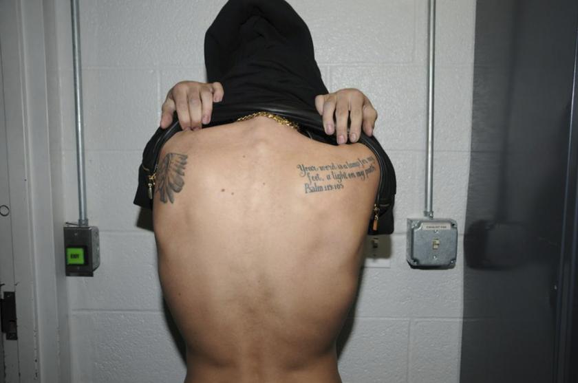 Canadian pop singer Justin Bieber shows a tattoo on his back while in police custody in Miami Beach, Florida January 23, 2014 in this Miami Beach Police Department handout released to Reuters on March 4, 2014.u00c2u00a0u00e2u20acu201d Reuters pic