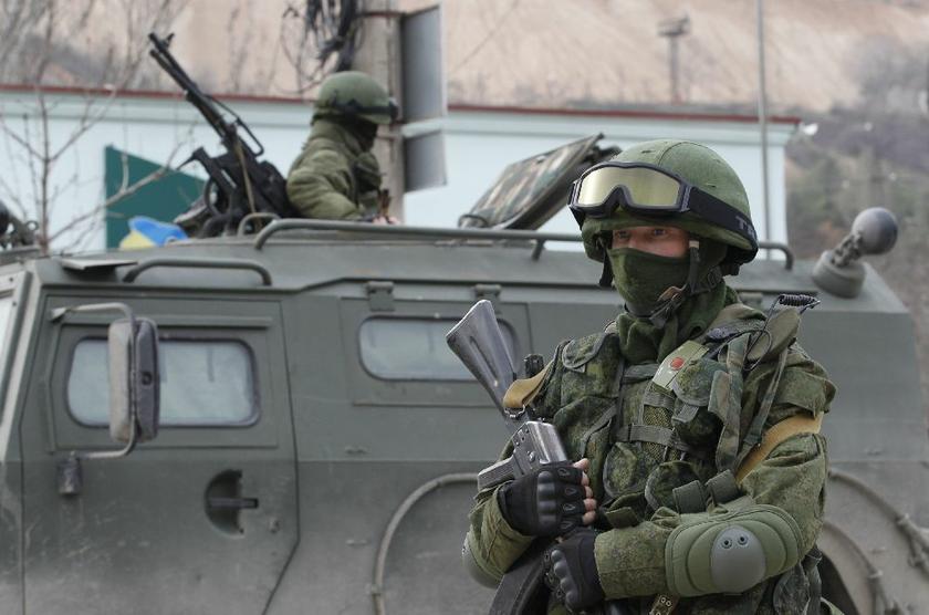 Armed servicemen wait in Russian army vehicles outside a Ukranian border guard post in the Crimean town of Balaclava March 1, 2014 Reuters