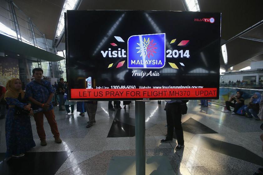 An information screen displays a message u00e2u20acu02dcLet Us Pray For Flight MH370u00e2u20acu2122, regarding the missing Malaysia Airlines flight, at Kuala Lumpur International Airport in Sepang March 8, 2014.u00e2u20acu201dReuters pic