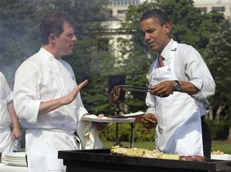 Flay (left) talks President Barack Obama through the finer points of grilling as the president hosts a barbeque for students on the South Lawn of the White House June 19, 2009. — Reuters file pic