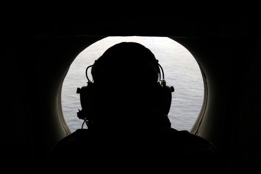 A crew member aboard a Royal New Zealand Air Force P-3K2 Orion aircraft searches for missing Malaysian Airlines flight MH370 over the southern Indian Ocean. u00e2u20acu201d Reuters pic