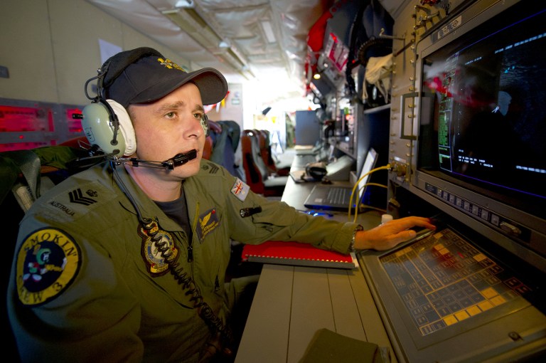 A hand-out photo taken on March 19, 2014 shows a Royal Australian Air Force Airborne Electronics analyst watching a radar screen for signs of debris on board an AP-3C Orion over the Southern Indian Ocean. u00e2u20acu201d AFP pic