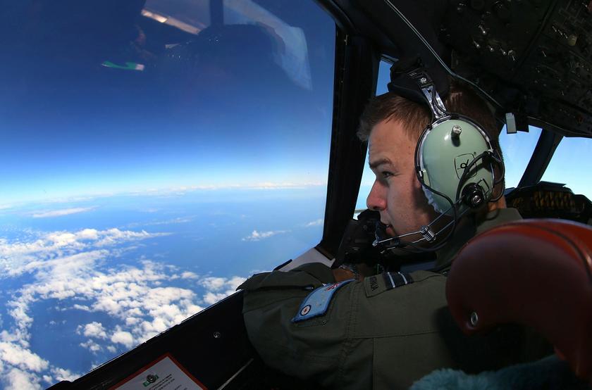 Flight Lieutenant Russell Adams looks out from the cockpit of a Royal Australian Air Force (RAAF) AP-3C Orion aircraft while searching for the missing Malaysia Airlines Flight MH370 over the southern Indian Ocean March 26, 2014. — Reuters pic