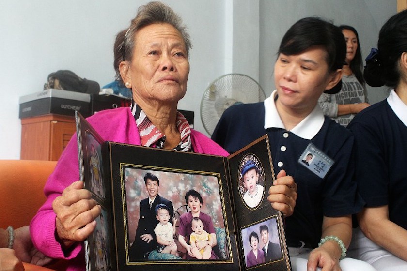 Grieving Indonesian mother Suharni displays a portrait of her son Sugianto Lo and wife Vinny Chynthya who are both passengers of the missing Malaysia Airlines flight MH370 from their residence in Medan March 10, 2013. u00e2u20acu201d AFP pic