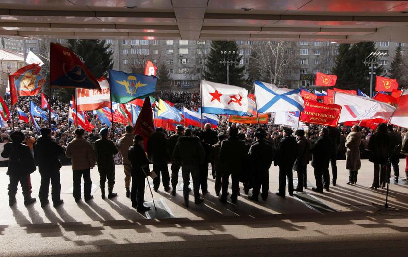 Speakers and spectators carry flags and placards to support Russian speakers living in Crimea and Ukraine, in Russiau00e2u20acu2122s Siberian city of Krasnoyarsk March 13, 2014. About 5500 people took part in the meeting organised by the regional Council of veterans 