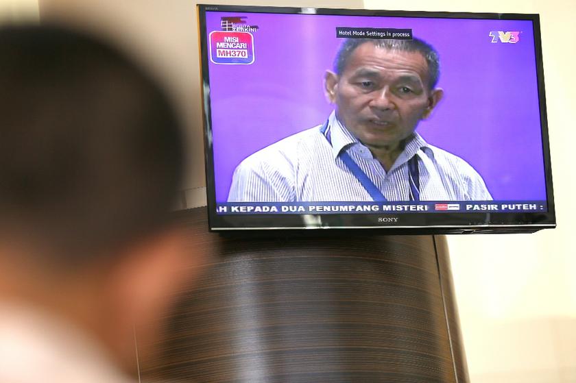 A relative of a passenger on the missing MH370 flight watches MAS CEO Ahmad Jauhari Yahya during a televised news conference at the Everly Hotel in Putrajaya March 10, 2014. u00e2u20acu201d Picture by Saw Siow Feng