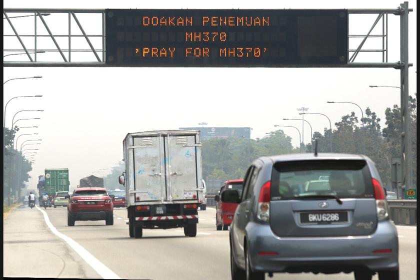 A 'Pray for MH370' message displayed at the digital board at the Projek Lebuhraya Utara Selatan (PLUS) expressway near the E6 link. u00e2u20acu201d Picture by Saw Siow Feng