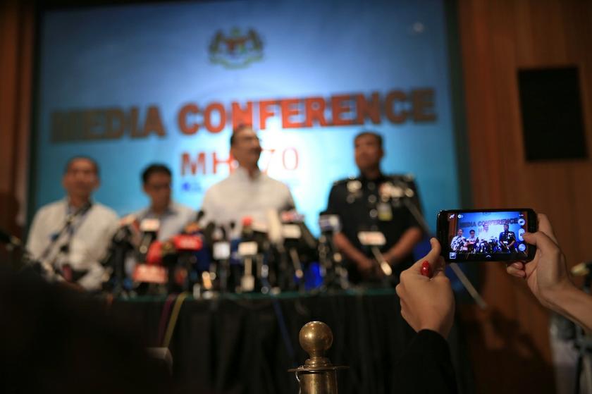 A person holding a smartphone takes a picture of the MH370 press conference at Sama Sama Hotel in Sepang, on March 16, 2014. u00e2u20acu201d Picture by Saw Siow Feng