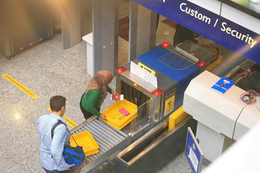 Passengers putting their hand luggage through the X-ray machines at a customs checkpoint at the Kuala Lumpur International Airport in Sepang, on March 21, 2014. u00e2u20acu201d Picture by Saw Siow Fengn