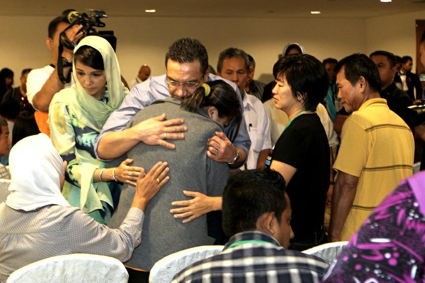 Acting Transport Minister Datuk Seri Hishammuddin Hussein hugs the family member of a passenger on board the missing MAS flight MH370 at the Everly Hotel in Putrajaya, on March 29, 2014. 
