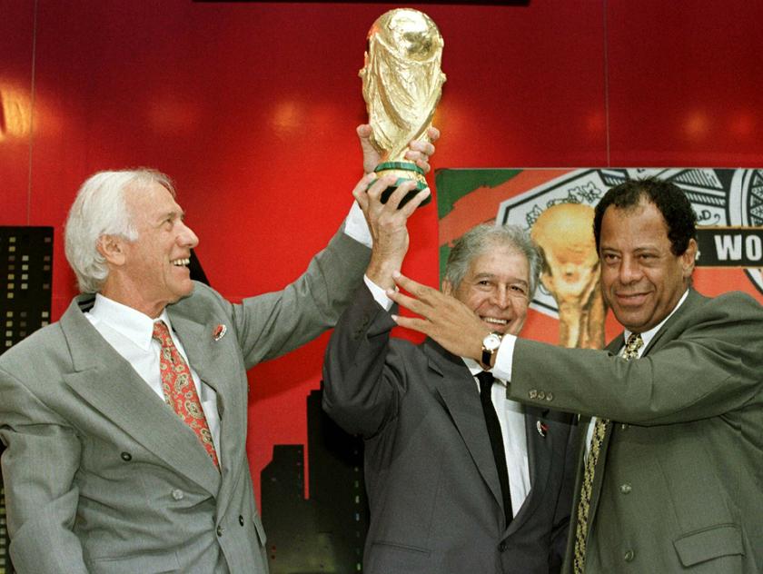 Former Brazilian World Cup team captains (L-R) Hideraldo Luiz Bellini (1958), Mauro Ramos (1962) and Carlos Alberto Torres (1970) hold up the FIFA trophy as it was officially presented to the nation's governing soccer body (CBF) in Rio de Janeiro, in this
