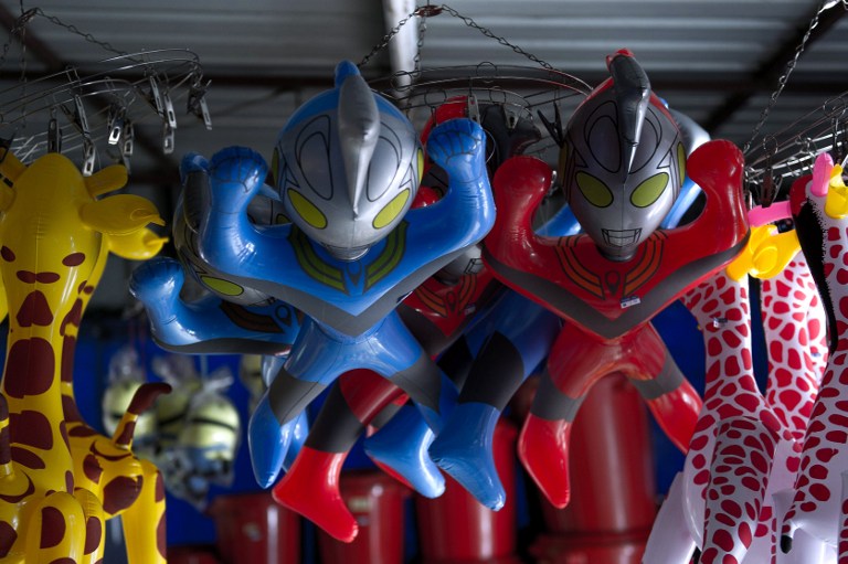 Plastic toys of Japanese animation superhero 'Ultraman' hang from the ceiling of a shop for sale in Karak, some 80 kilometres east of Kuala Lumpur on March 7, 2014. u00e2u20acu201d AFP pic