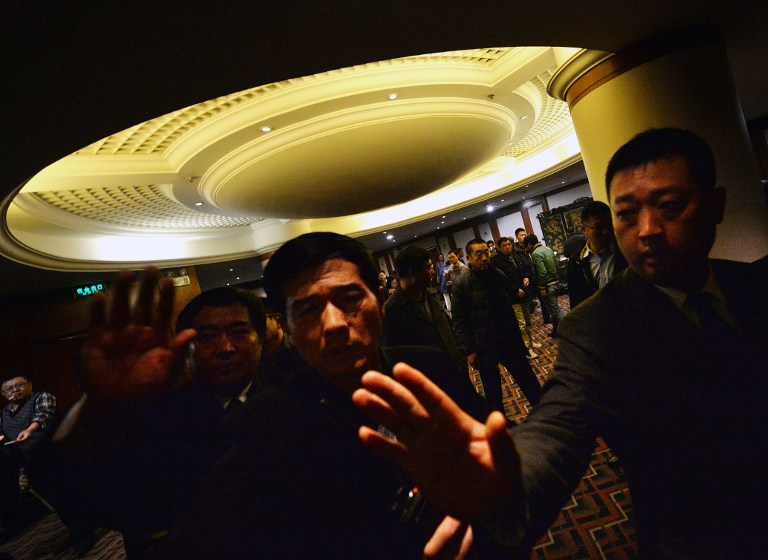 Security blocks journalists from the meeting with relatives of passengers from the missing Malaysia Airlines Boeing 777-200 plane and the Malaysian ambassador at the Metro Park Lido Hotel in Beijing on March 12, 2014. u00e2u20acu201d AFP pic